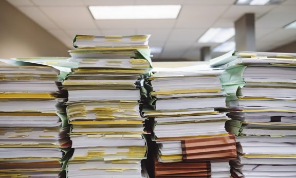 Stack of organized paperwork and files in an office setting